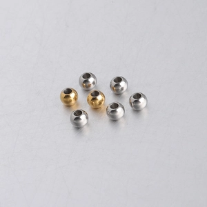 Close-up of 5mm gold and silver stainless steel spacer beads for DIY jewelry making