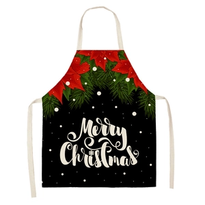 Detail of linen Christmas apron with red poinsettia and Merry Christmas print