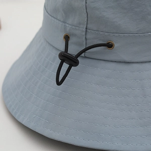 Adjustable quick-dry kids sun hat in light blue with toggles and mountain print detail