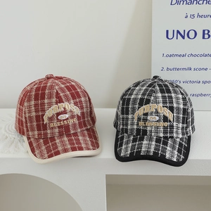 Close-up of retro plaid baseball caps with Purpose Blessing embroidery in tweed fabric