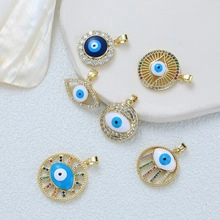 Detail of six 18K gold plated evil eye pendants with colorful enamel and sparkling crystals