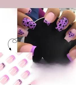 Macro detail of purple leopard heart press on nails with hand-painted patterns