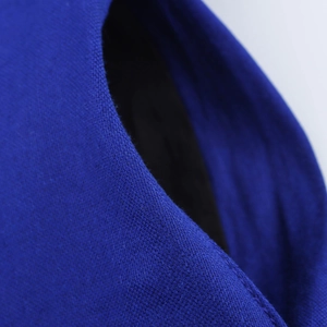 Detailed close-up of dark blue woven fabric texture and premium stitching craftsmanship