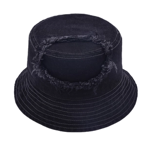 Distressed black denim bucket hat featuring frayed hole design and wide brim for sun protection