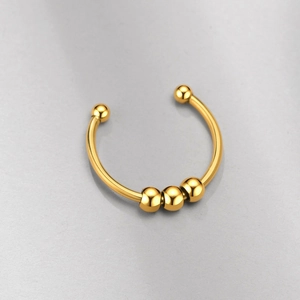 Close-up of golden polished stainless steel open ring with sliding beads detail