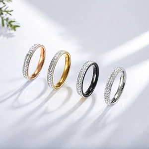 Detailed view of four titanium steel rings with double-row rhinestones in various colors.