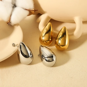 Minimalist 18K gold and silver waterdrop earrings with a polished mirror finish on beige surface