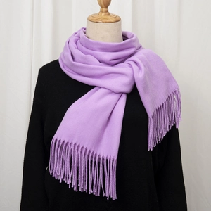 Detail shot of lavender faux cashmere scarf with soft tassels on a mannequin