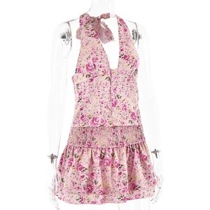 Detail of pink floral halter neck top with elastic waist and vibrant petal patterns