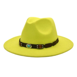 Detail of yellow wool fedora hat featuring decorative brown leather band with turquoise bead