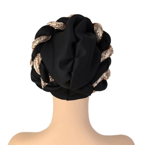Detailed back view of a black turban hat with intricate gold sequin braid embellishments