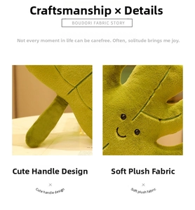 Detail of green leaf plush pillow with embroidered smile face and soft fabric texture