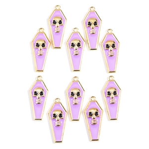Detail showing 10 light purple and gold coffin pendants with skull charms for DIY jewelry