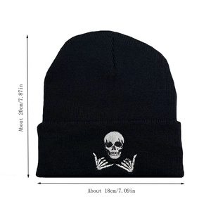 Detail showing skull embroidery and dimensions on black knit beanie for winter