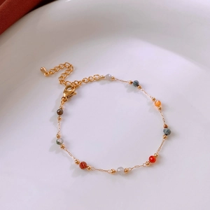 Detail of gold chain necklace with colorful beads and adjustable lobster clasp