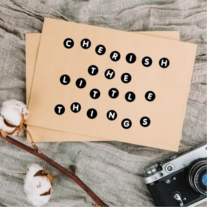 Detail of 0.5 inch letter stickers with Cherish The Little Things text on kraft cards