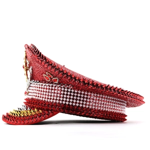 Close-up of red sequins, silver studs, and pearls on decorative festival captain hat