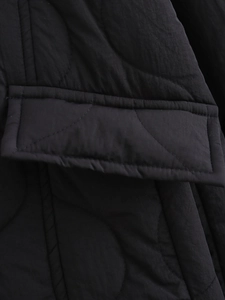 Detail of black quilted fabric showing premium gourd patterns and pocket stitching