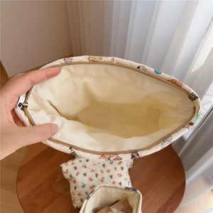 Top macro view of the open quilted cotton makeup bag showing spacious interior and animal print