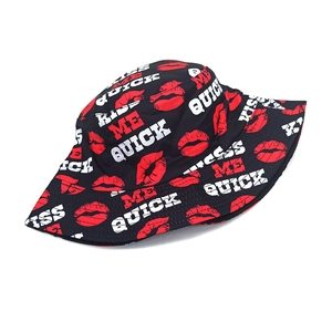 Detail of black cotton bucket hat with red lip prints and Kiss Me Quick text patterns