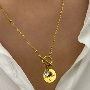 Golden stainless steel necklace with toggle clasp featuring heart round pendant and crystal