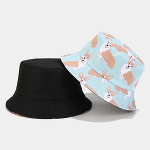 Reversible bucket hat featuring solid black and light blue cartoon corgi pattern print