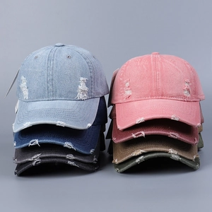 Macro detail of distressed washed denim baseball caps showing diverse vintage colors