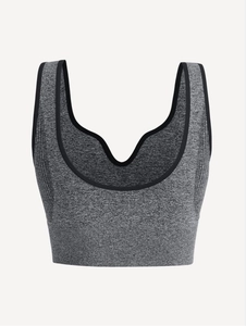 Detail of seamless grey marl yoga bra with elastic fabric and black contrast piping