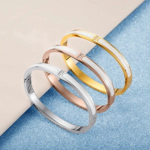 Minimalist 18K gold plated stainless steel bangles with white enamel and tiny crystals