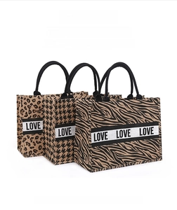 Three jute tote bags featuring leopard, houndstooth, and zebra prints with LOVE webbing