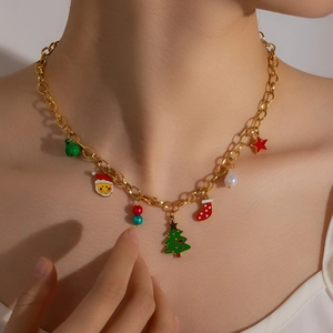 Detailed view of a gold Christmas necklace with festive enamel charms worn by a model