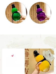 Detail view of colorful translucent gourd-shaped water bottles with sleek black lanyards