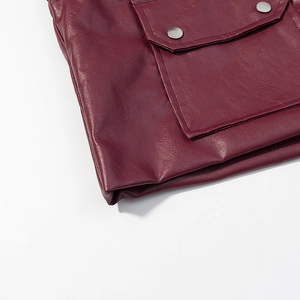 Detail of burgundy leather jacket with fine texture and silver metallic button accents