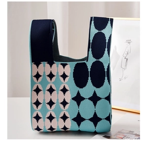 Detail of knit handbag featuring geometric pattern and navy blue contrast textures