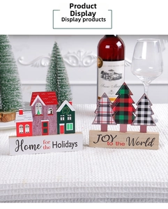 Detailed view of Christmas wooden house and plaid tree table ornaments for festive decor