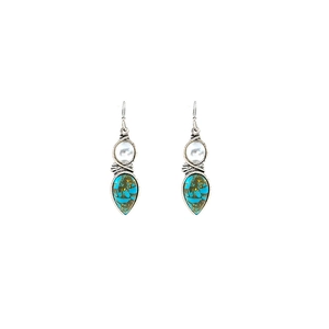 Detail of bohemian drop earrings with turquoise stones and white beads on silver base