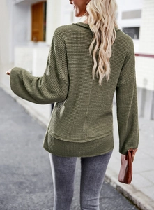 Back view of army green waffle knit long sleeve top featuring casual loose fit design