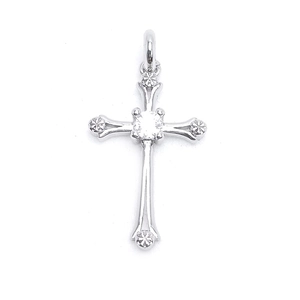 Detail of silver cross pendant featuring a central clear stone and textured metal ends