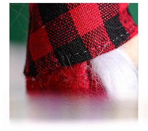 Detail of red and black buffalo plaid knitted hat with white faux fur trim for Christmas gnome