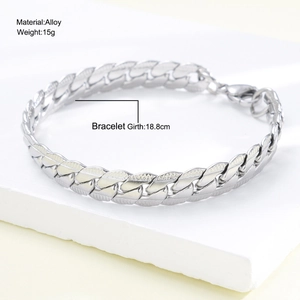 Silver mens Cuban chain bracelet in polished stainless steel on stone background