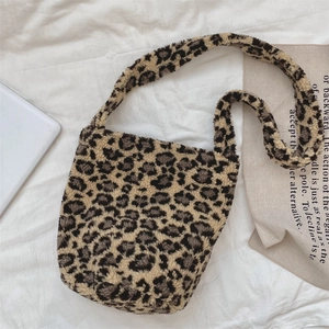 Detail of soft leopard print faux fur bucket bag showing plush texture and shoulder strap