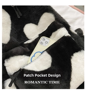 Detail of plush heart-pattern bag featuring a functional front pocket for smartphone storage