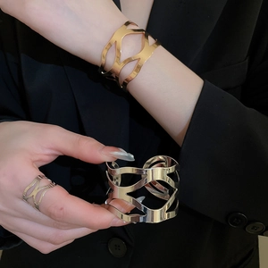 Chic hollow geometric gold and silver bangle set with matching ring on fashion model