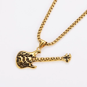 Macro shot of gold guitar pendant with totem patterns and sleek venetian chain