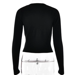 Rear view of black slim-fit knit top with round neck and ribbed hem on model
