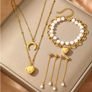 Chic gold jewelry set with heart and moon pendants, pearls, necklace, and earrings
