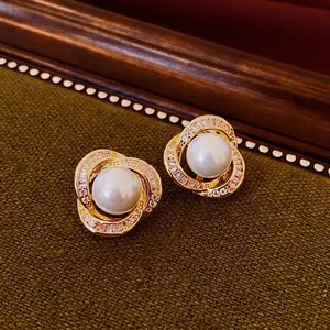 Exquisite pearl stud earrings with gold spiral winding and sparkling zircon accents