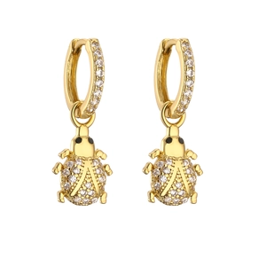 Detailed view of ladybug charm earrings with gold finish and sparkling zircon stones