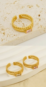 Detail of adjustable gold ring featuring pink and white rectangular zircon with chain texture