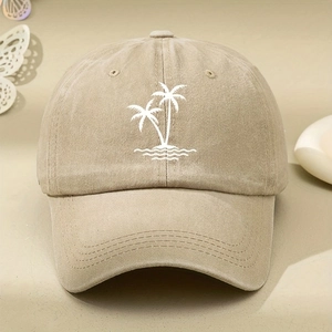 Close-up of khaki baseball cap with white palm tree embroidery and adjustable strap
